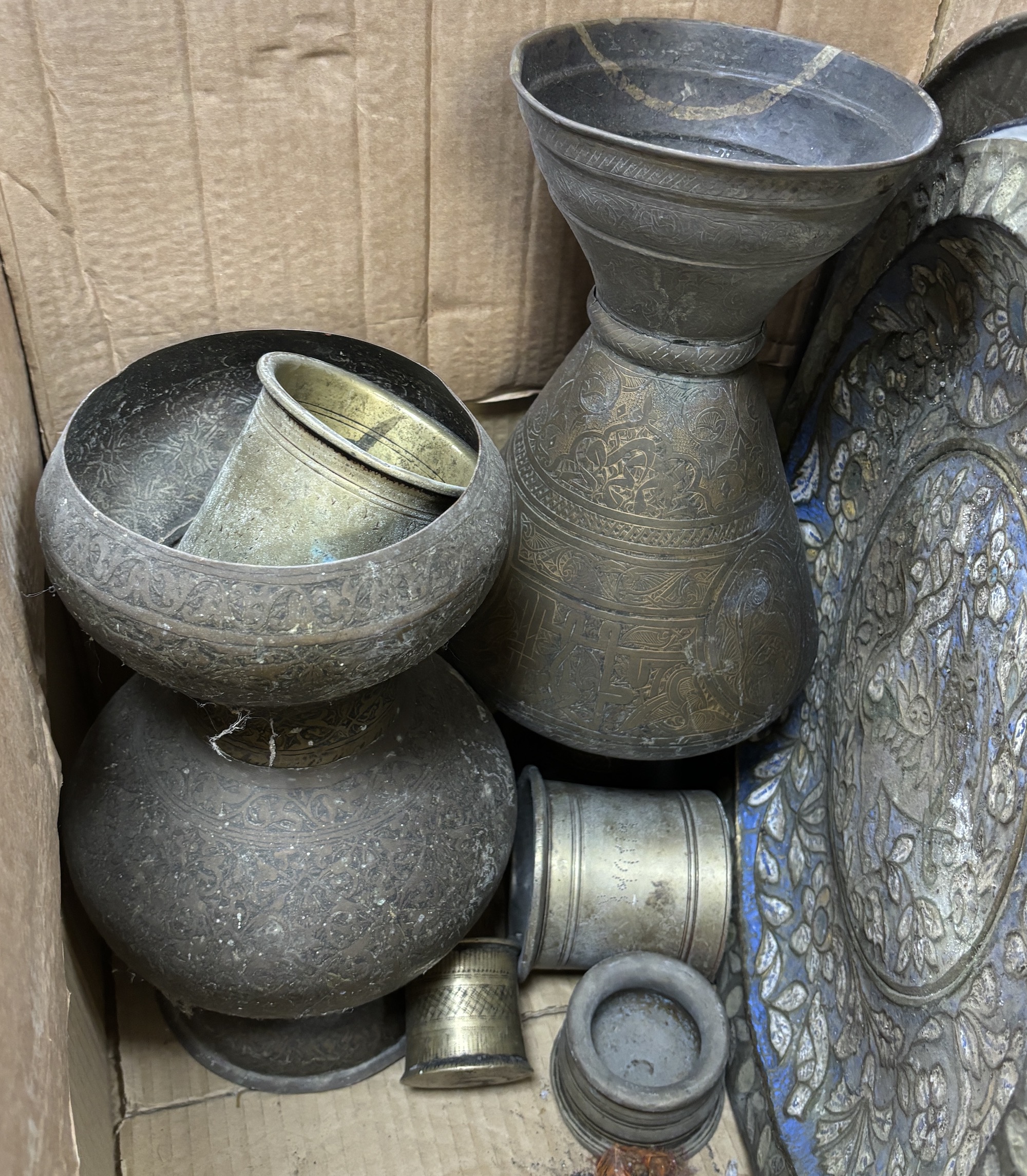 A collection of Indian metalware, including pots and measures, five trays, two vases, etc. tallest 40cm